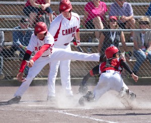  Tyler Pauli dives over the Singapore catcher to score a run during action July 19 from the ISF Junior Men’s World Softball Championship. (Photo by Maddy Flanagan, www.maddysphotos.com, click to enlarge)